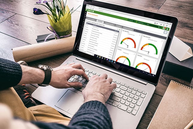 Vecta dashboards being presented to African salesperson on a laptop